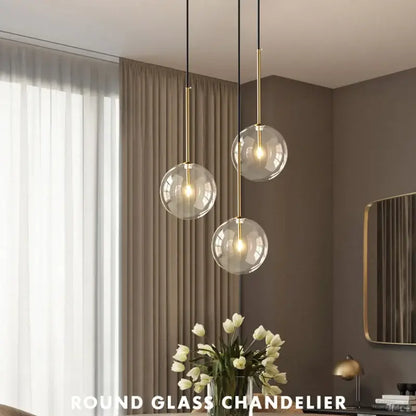 Modern round pendant light with clear glass spherical bulbs and gold-toned metal rods for kitchen suspension