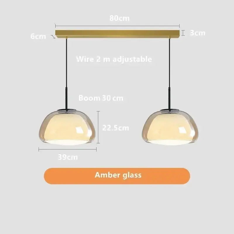Modern amber glass jelly pendant lamp with brass-finished bar and adjustable black cords for living room and dining room