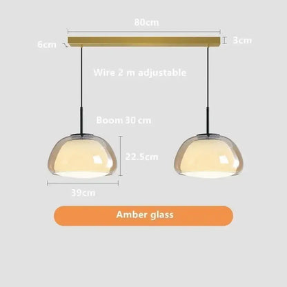 Modern amber glass jelly pendant lamp with brass-finished bar and adjustable black cords for living room and dining room