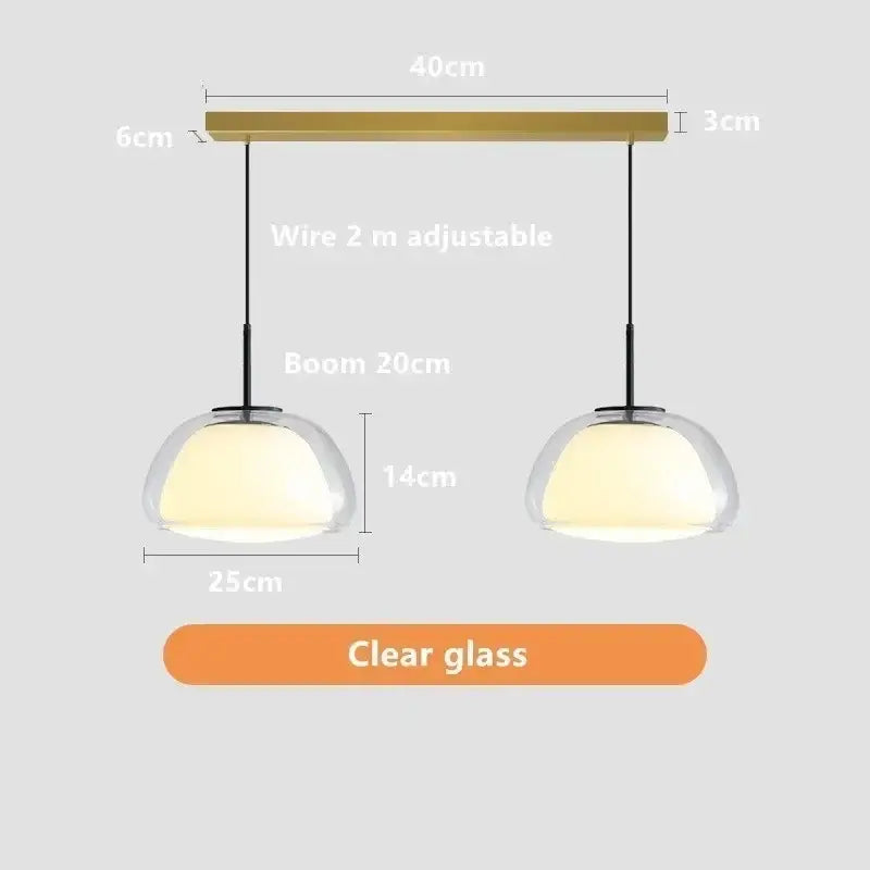 Modern clear glass jelly pendant lamp with brass-finished bar featuring two domes for living room and dining room