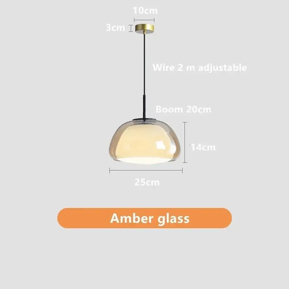 Modern clear glass jelly pendant lamp with sleek amber dome, brass hardware, and black wire for living or dining room