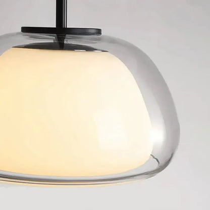 Modern clear glass jelly pendant lamp with warm glowing shade and black metal hardware for living room and dining room