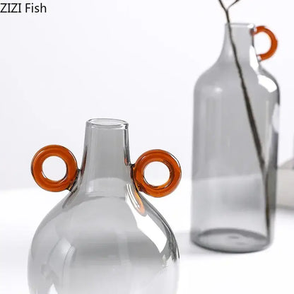 Modern clear glass vase with gray tint and two orange circular handles for living room decorbites clear glass decor