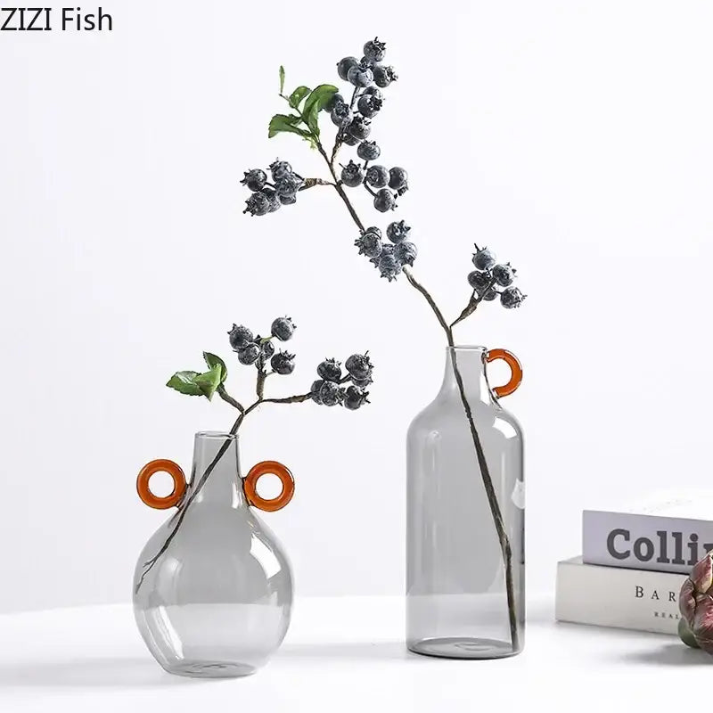 Modern clear glass vase with orange circular handles featuring one rounded and one taller design for living room decorbites clear glass decor