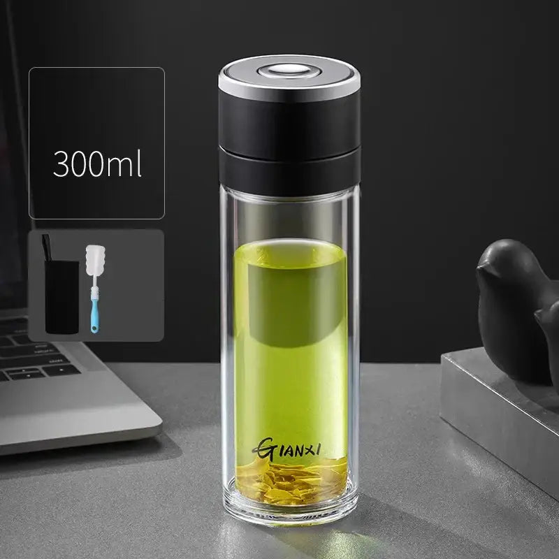 Modern clear insulated decorbites insulated glass cup filled with green tea featuring black and silver lid