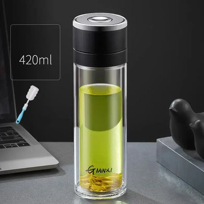 Modern clear insulated decorbites insulated glass cup with black silver lid holding green tea leaves in base