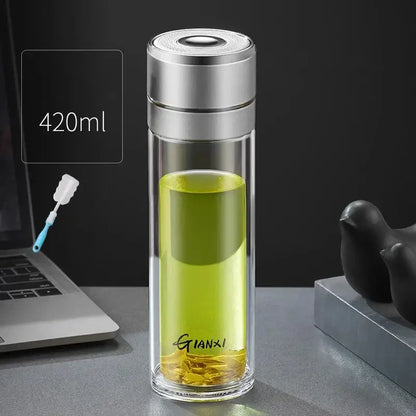 A sleek 420ml modern clear decorbites insulated glass cup with silver lid filled with green tea and gianxi branding