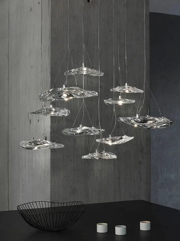 Modern clear patterned glass staircase pendant light features hand-blown glass with an organic design for dining rooms