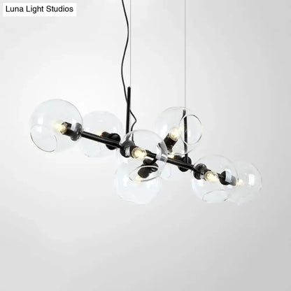 Modern black metal lighting fixture with clear smoke glass spheres and exposed bulbs for dining room use
