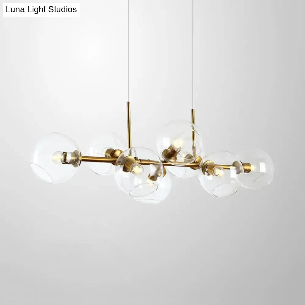 Modern black and gold lighting fixture with clear smoke glass globe shades and eight bulbs for dining room use