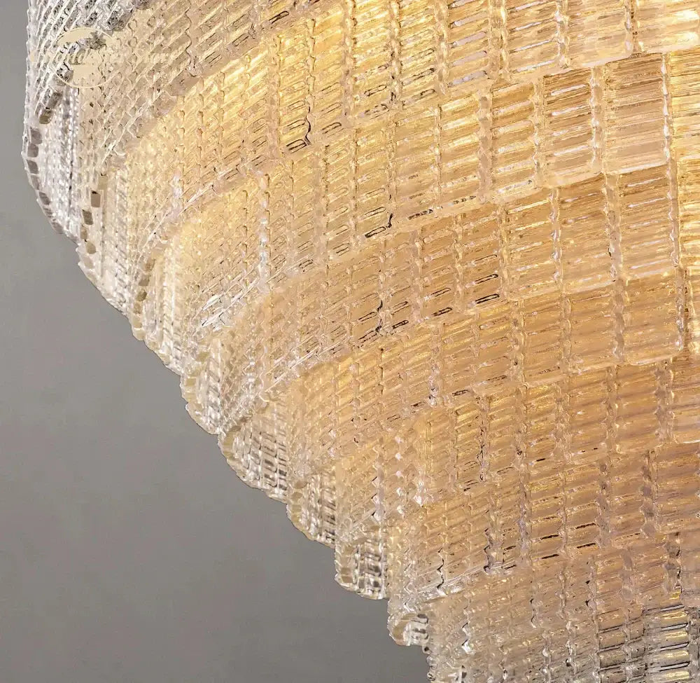 Modern clear smoke glass oval chandelier with golden tiered brass frame and cascading rectangular glass prisms for dining room decorbites clear smoke