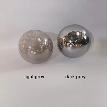 Two spherical glass shade replacements in light grey and dark grey with reflective surfaces for living room globes