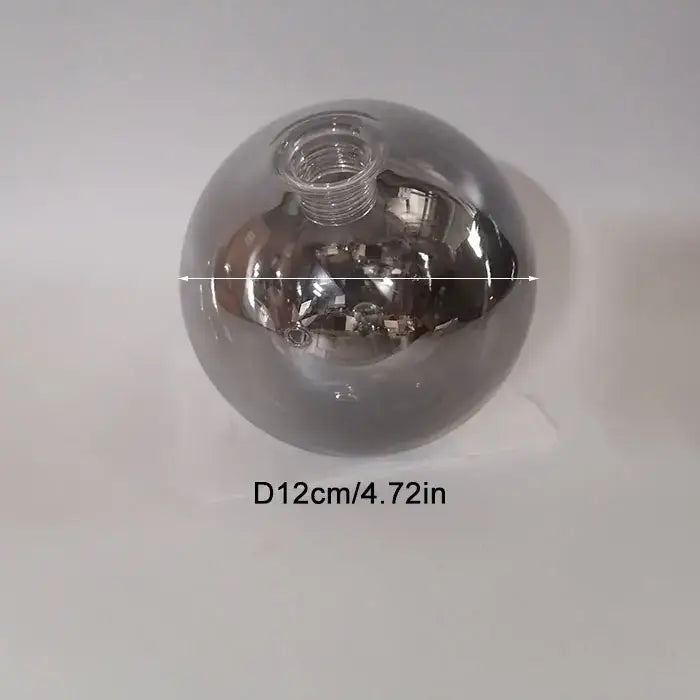 A sleek 12cm diameter spherical glass shade replacement with metallic silver finish and threaded neck for living room globe