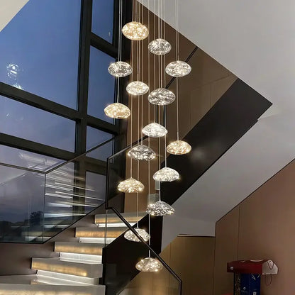Modern cloud glass crystal pendant chandelier with translucent pendants serves as a focal point for dining rooms