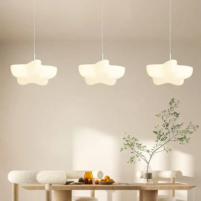 Three off-white cloud white floating pendant lights with matte finish hang above wooden dining table decorbites cloud white
