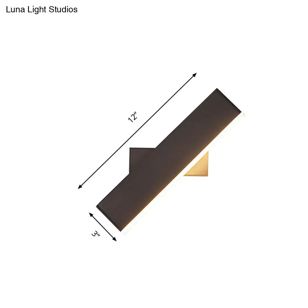 Modern coffee white rectangular sconce with a sleek black angular design and gold accent base for bedroom LED lighting