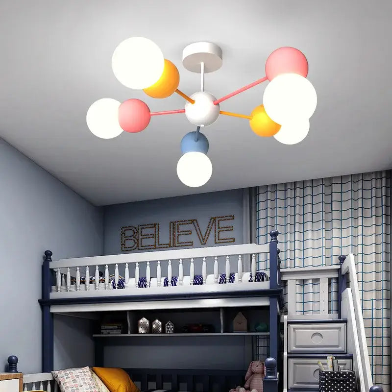 A modern colorful cartoon led chandelier light with white pink yellow and blue spherical bulbs for kids bedroom