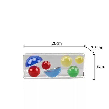 Clear acrylic container holding colorful crystal spheres in red blue yellow and green for modern living room decor