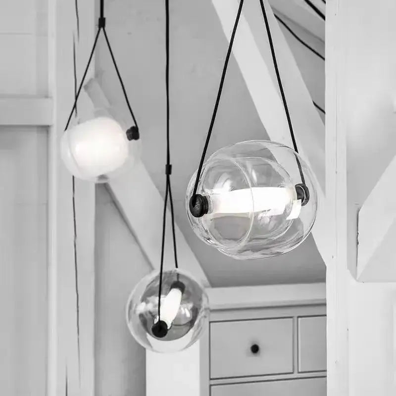 Modern colorful czech glass capsule pendant light with clear glass globe and black cords for dining room use