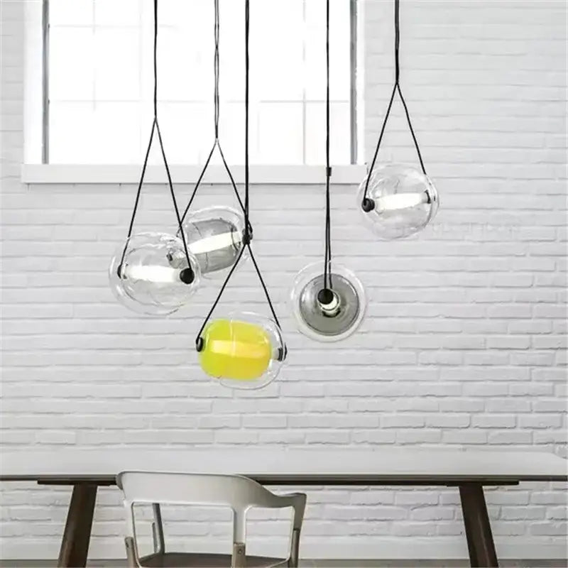 Modern colorful czech glass capsule pendant light with clear glass spheres and yellow interior for dining room use