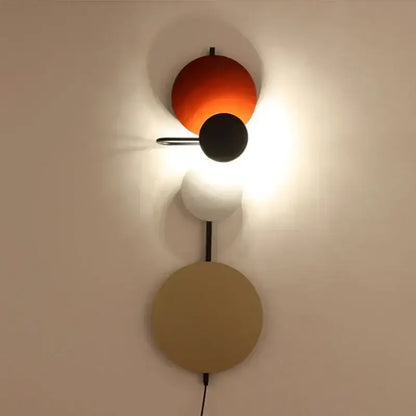 Modern colorful geometric led wall lamp with stacked spherical shades in orange black white and beige for bedroom decor