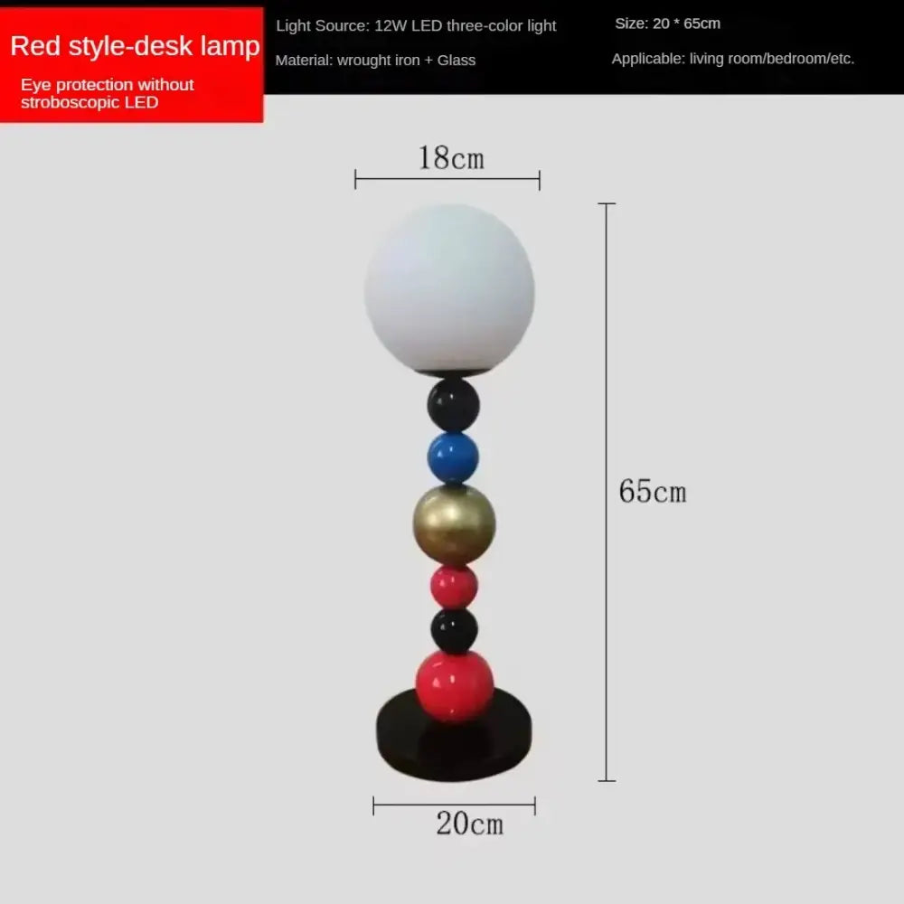 Modern colorful glass ball floor lamp with a red desk lamp style, white glass globe shade, and slender multicolor base