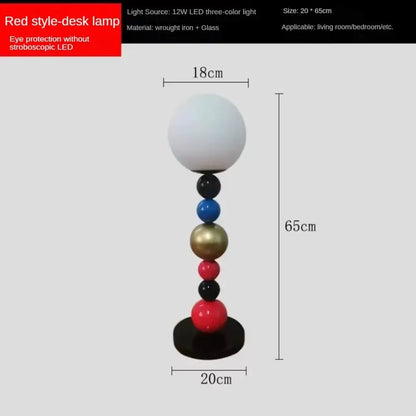 Modern colorful glass ball floor lamp with a red desk lamp style, white glass globe shade, and slender multicolor base