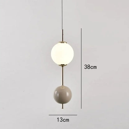 Modern colorful glass ball led pendant light with frosted white and matte beige orbs on brass rod for dining room decorbites
