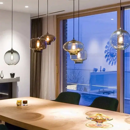 Modern colorful glass bowl pendant lights feature warm amber-toned bulbs and sleek black cords for kitchen dining decorbites glass bowl pendant