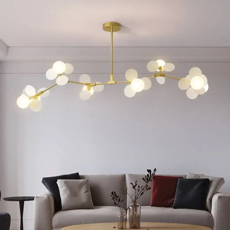 Gold-toned modern decorbites branch chandelier with frosted glass globe bulbs for living room lighting decor
