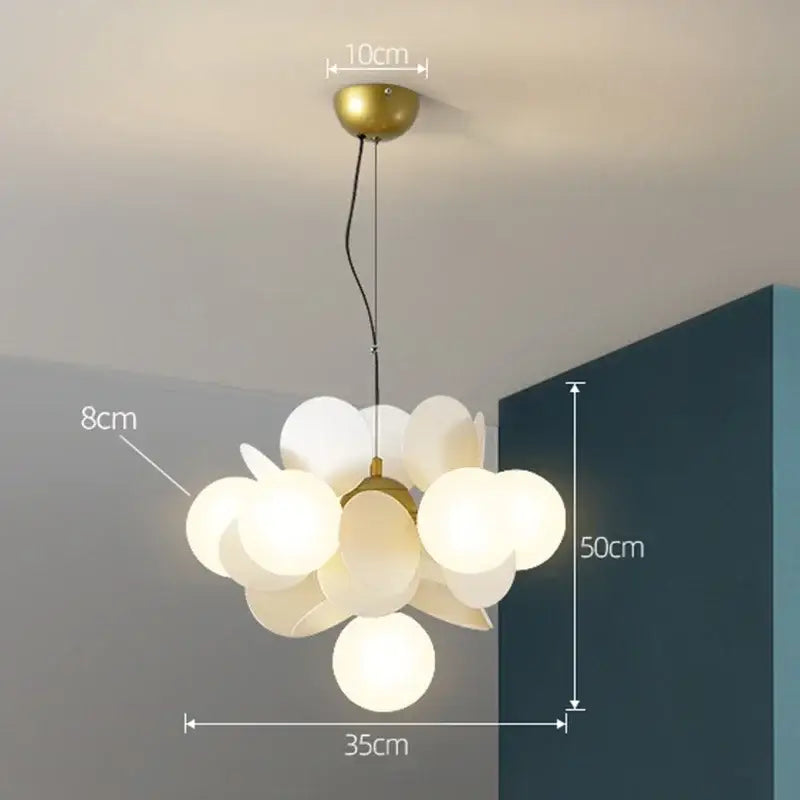 A modern colorful glass decorbites branch chandelier with brass metal frame and frosted glass spheres for living room