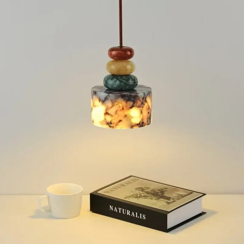 Modern colorful stone led pendant lamp with amber marbled glass shade and stacked polished stones for dining room decorbites colorful stone