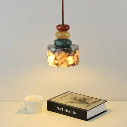 Modern colorful stone led pendant lamp with amber marbled glass shade and stacked polished stones for dining room decorbites colorful stone