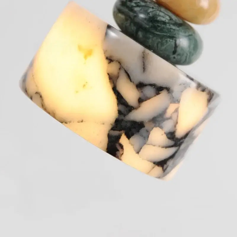 A rectangular resin ring with creamy white and dark gray swirls and stone fragments for decorbites colorful stone led pendant lamp