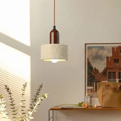 A modern pendant light with a textured concrete shade and dark wood neck in led yellow travertine decorbites led yellow