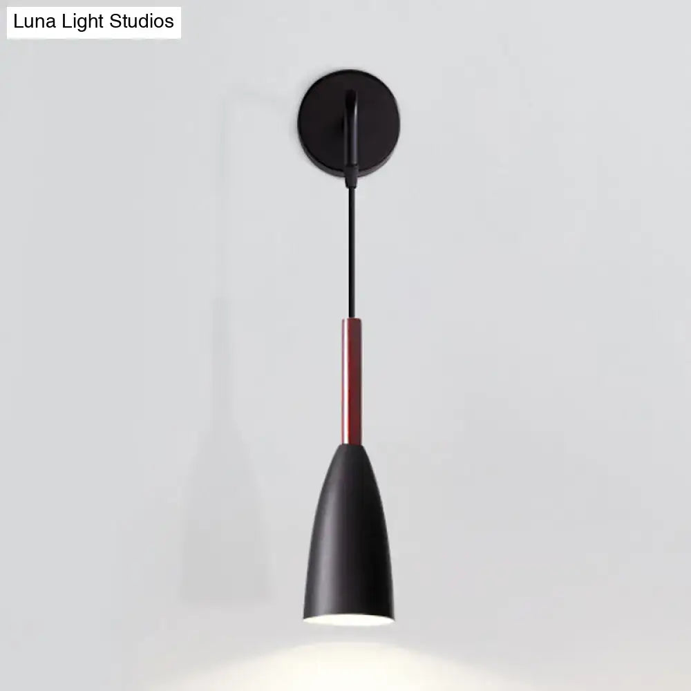 Modern conical black wall lamp with matte finish, sleek conical shade, red accent rod, and single bulb inch fixture