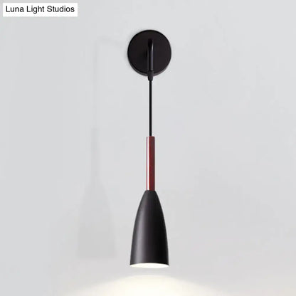 Modern conical black wall lamp with matte finish, sleek conical shade, red accent rod, and single bulb inch fixture