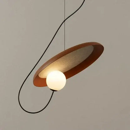 Modern copper and black grid led pendant light with warm matte circular shade and glowing bulb for dining room decorbites grid led