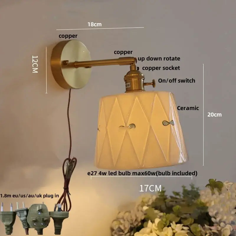 Copper-finished wall light fixture with an off-white geometric ceramic shade for modern bedroom sconces