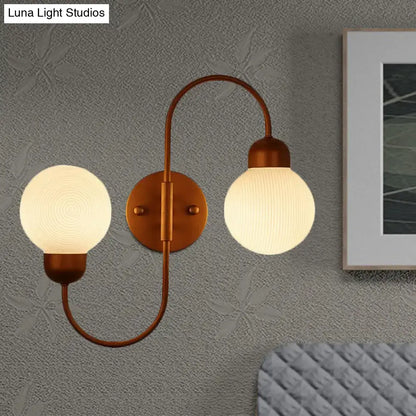 Modern copper spherical wall sconce with frosted white glass shades for living room lighting