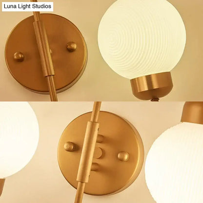 Modern copper and white glass spherical wall sconce with gold-toned frosted globe for living room lighting