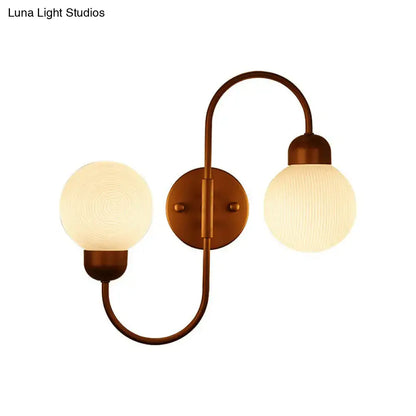 Antique brass double-arm living room spherical wall sconce with modern white frosted glass globe shades