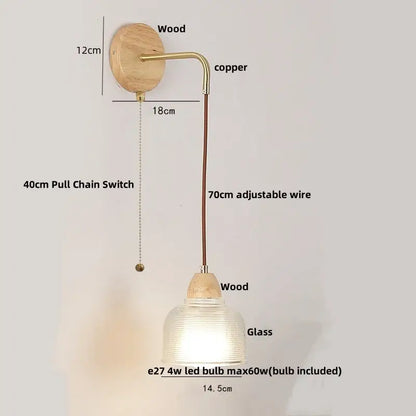 Modern copper and wood wall sconce with clear glass shade and pull chain switch featuring a natural wood base