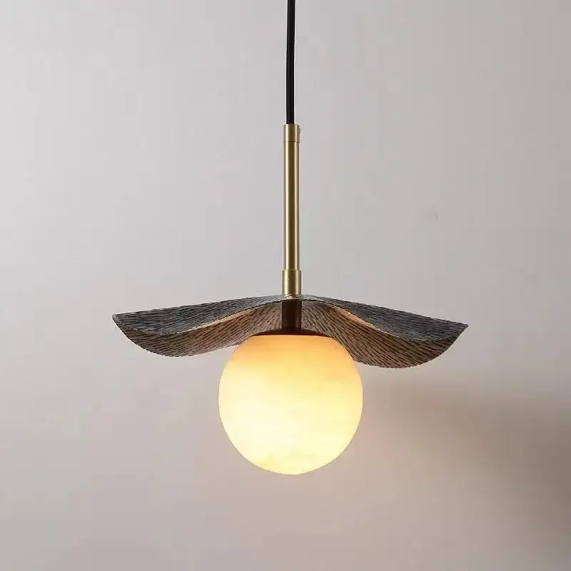 Modern copper bedside chandelier with warm-toned glass pendant, brass rod, and leaf-like shade for dining room decorbites copper bedside