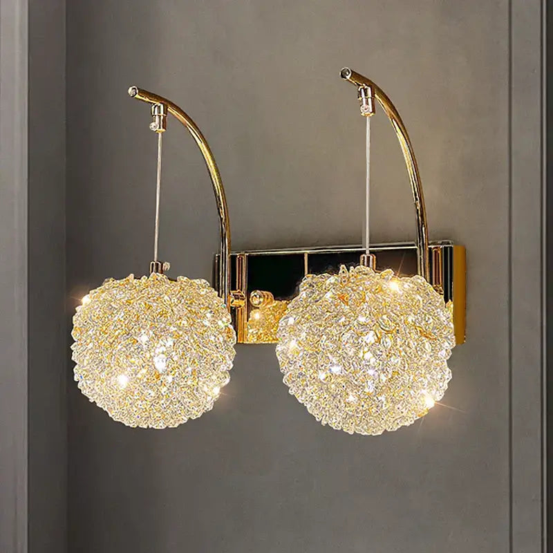 Modern copper crystal wall sconce with gold-toned finish and two sparkling crystal globe shades for living room decorbites lighting