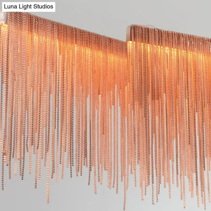 A modern decorbites contemporary metal gold led linear island pendant light with cascading copper-toned metal bead chains