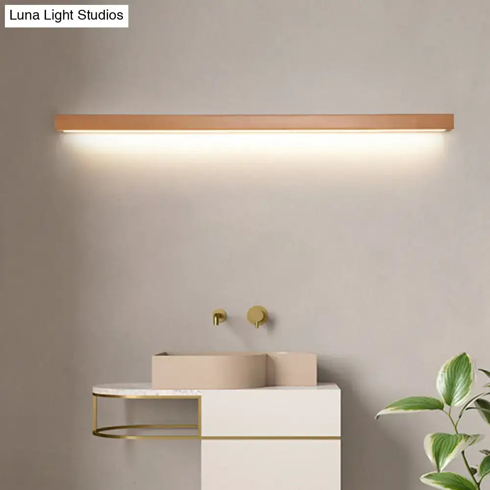A sleek modern copper linear shaped wall sconce with warm wooden finish and integrated led for living room lighting