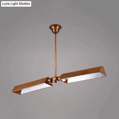Brass-finished modern copper metal triangle island pendant light with two angular rectangular lamp heads on a central rod