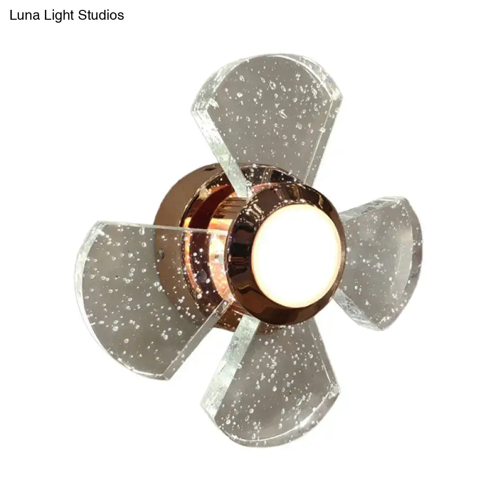 Modern copper starburst glass wall sconce with clear speckled fan-shaped shade and maximum bulb wattage of 60w