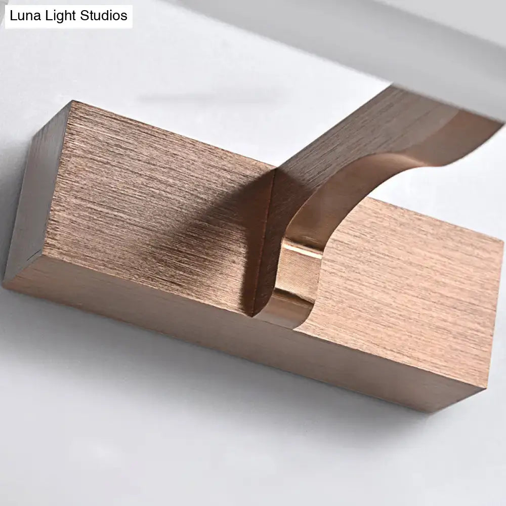 Modern copper wood grain wall light with sleek angular design and brushed metal accents featuring optimal fixture height